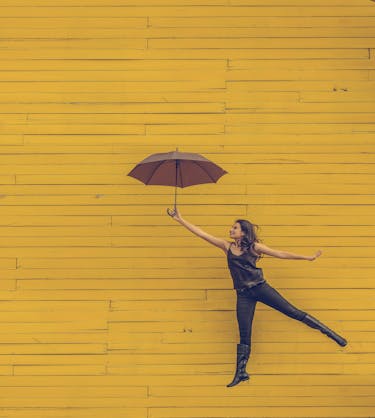 Woman jumping customer onboarding with client onboarding checklist