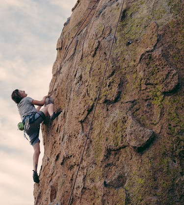 rock climber representing company scaling