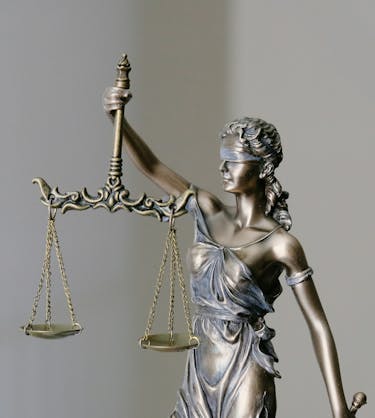Lady Justice representing vital types of compliance training.